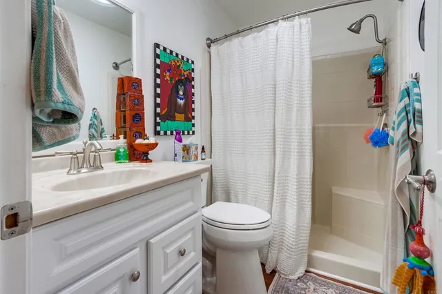a bathroom with a sink mirror vanity and toilet