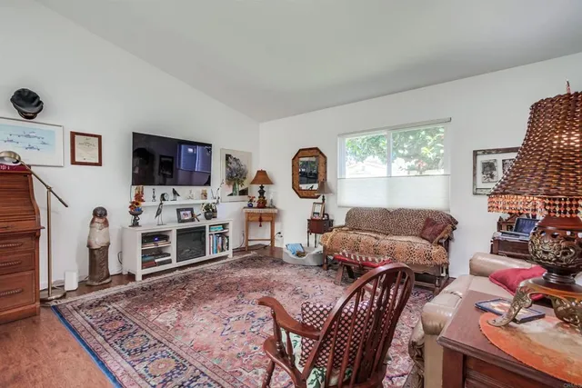 a living room with furniture a flat screen tv and a fireplace