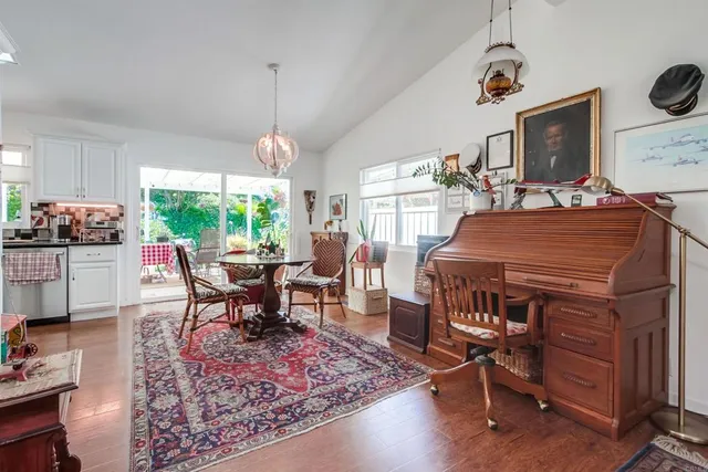 a living room with furniture a rug and a window
