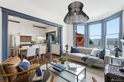 a living room with furniture a window and a fireplace