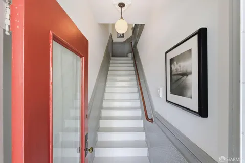 a view of a hallway with wooden floor and entryway
