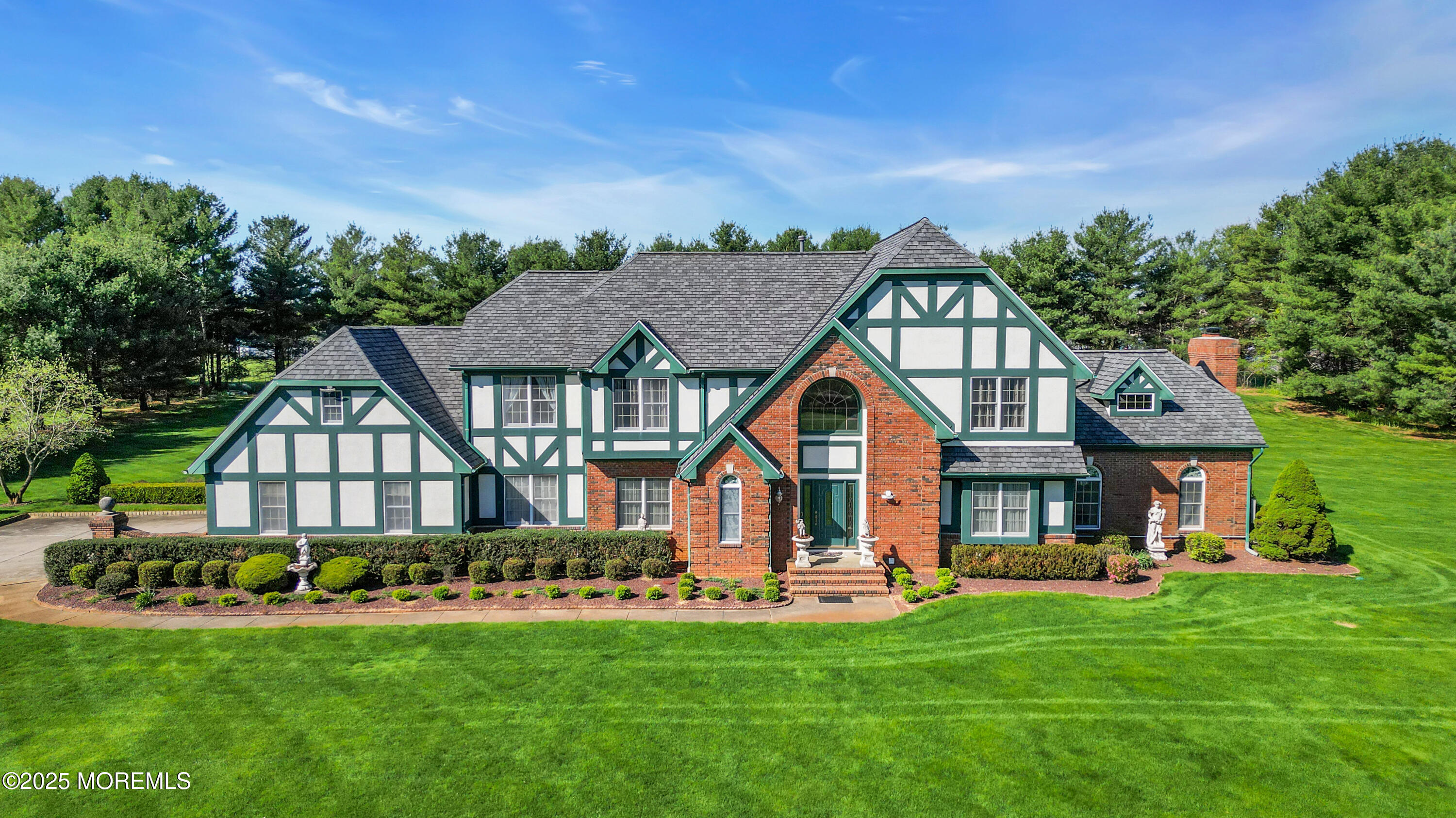 a front view of a house with a garden and deck