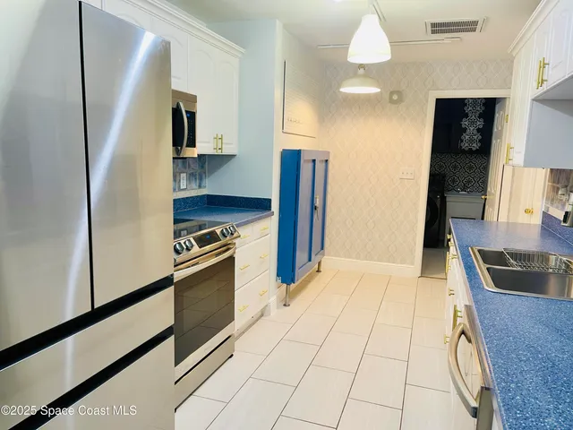 a kitchen with a sink and a stove top oven