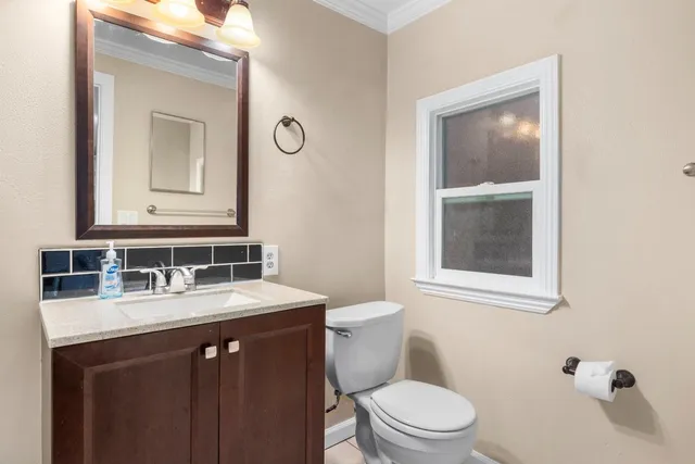 a bathroom with a granite countertop sink mirror and a bathtub