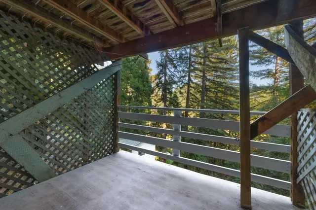 a view of balcony with wooden floor and fence