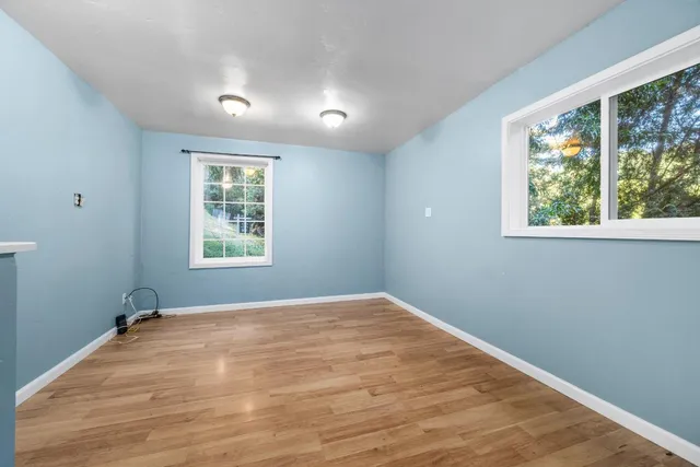 a view of a big room with wooden floor and closet