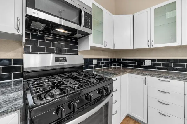 a bathroom with a sink vanity mirror and toilet