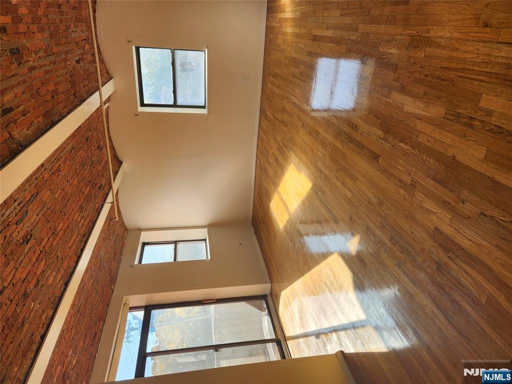 840 River Road, Unit 207 Edgewater, NJ 07020 - Photo 11 of 13 a view of an empty room with wooden floor and a window