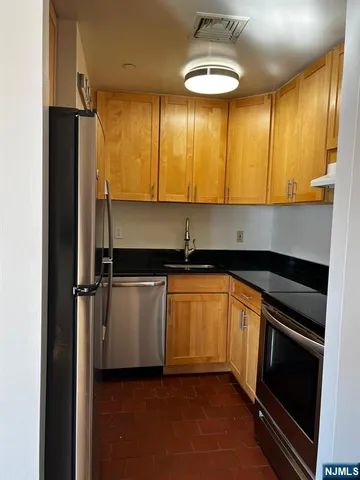 a kitchen with stainless steel appliances a refrigerator and sink