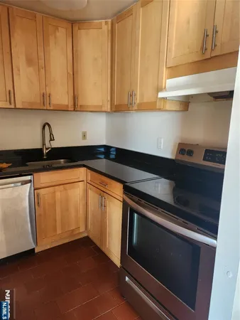 a kitchen with granite countertop white cabinets and sink