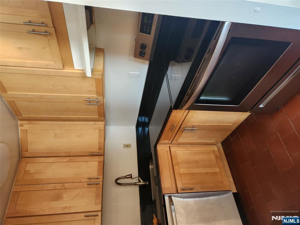 840 River Road, Unit 207 Edgewater, NJ 07020 - Photo 8 of 13 a kitchen with granite countertop white cabinets and sink