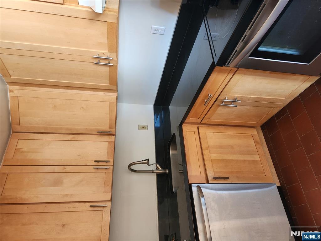 840 River Road, Unit 207 Edgewater, NJ 07020 - Photo 9 of 13 a kitchen with granite countertop white cabinets and sink