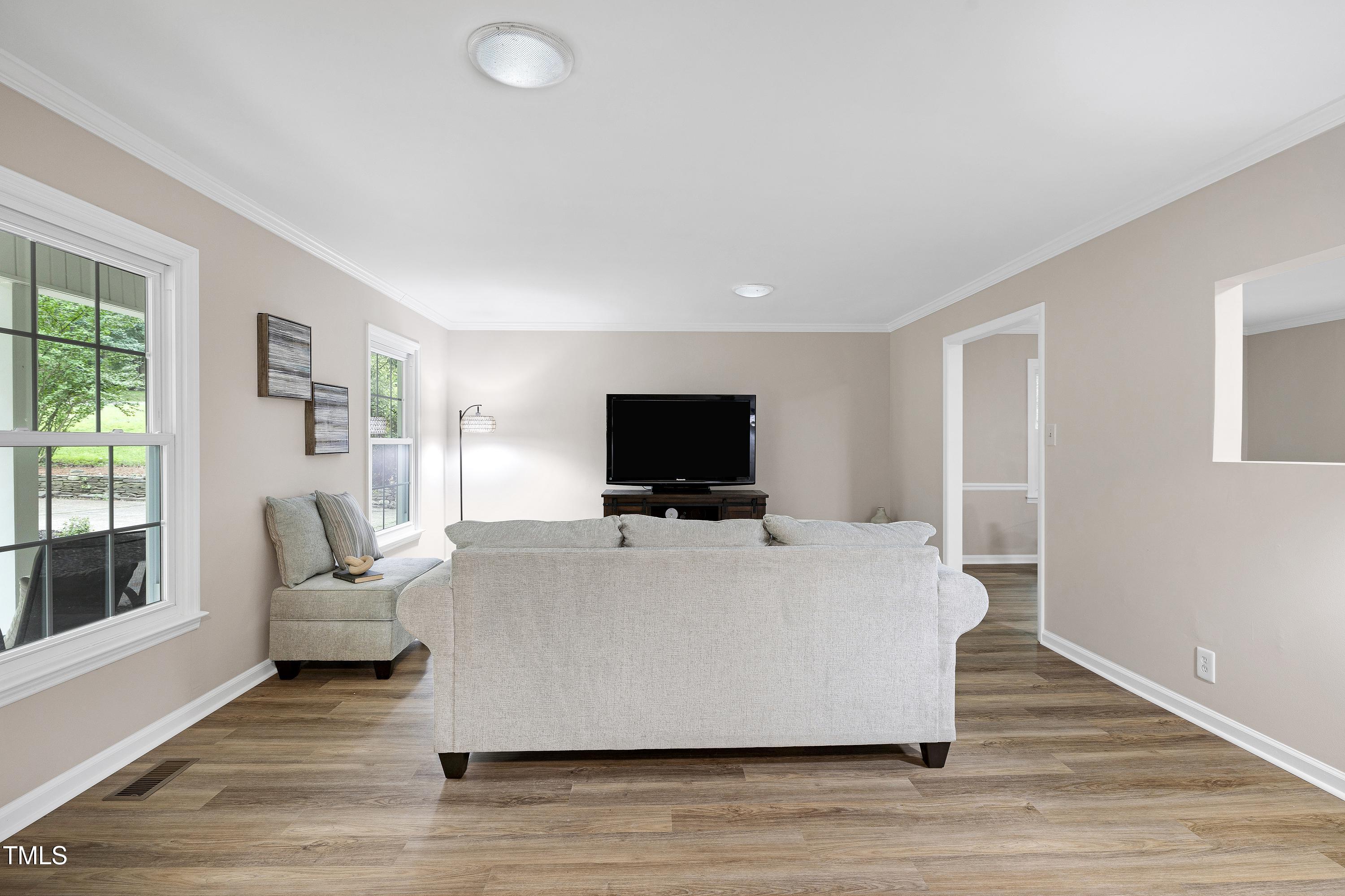 5121 Raintree Road Durham, NC 27712 - Photo 11 of 59 a living room with a flat screen tv and a couch