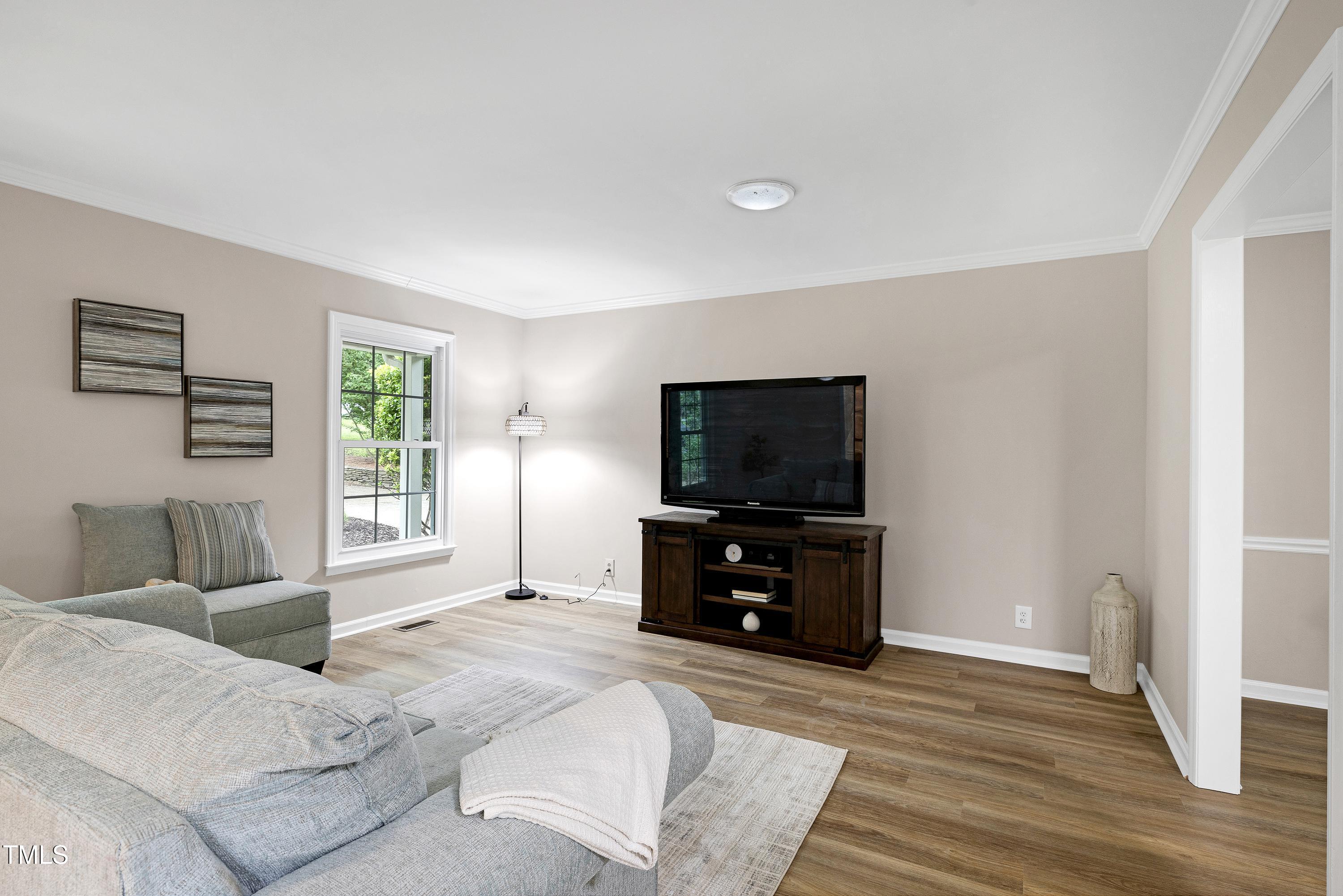 5121 Raintree Road Durham, NC 27712 - Photo 12 of 59 a living room with furniture and a flat screen tv