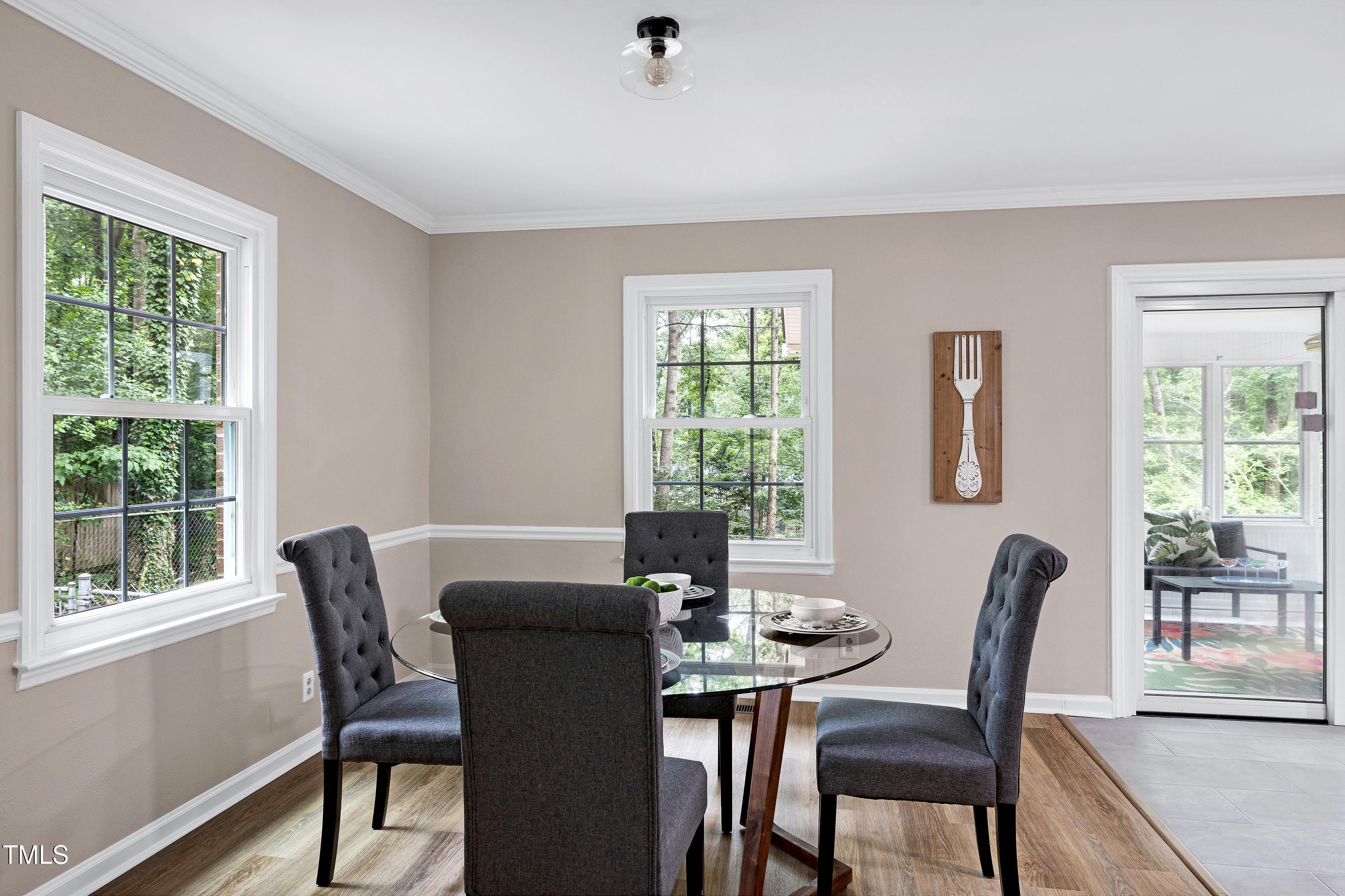 5121 Raintree Road Durham, NC 27712 - Photo 16 of 59 a view of a dining room with furniture window and outside view