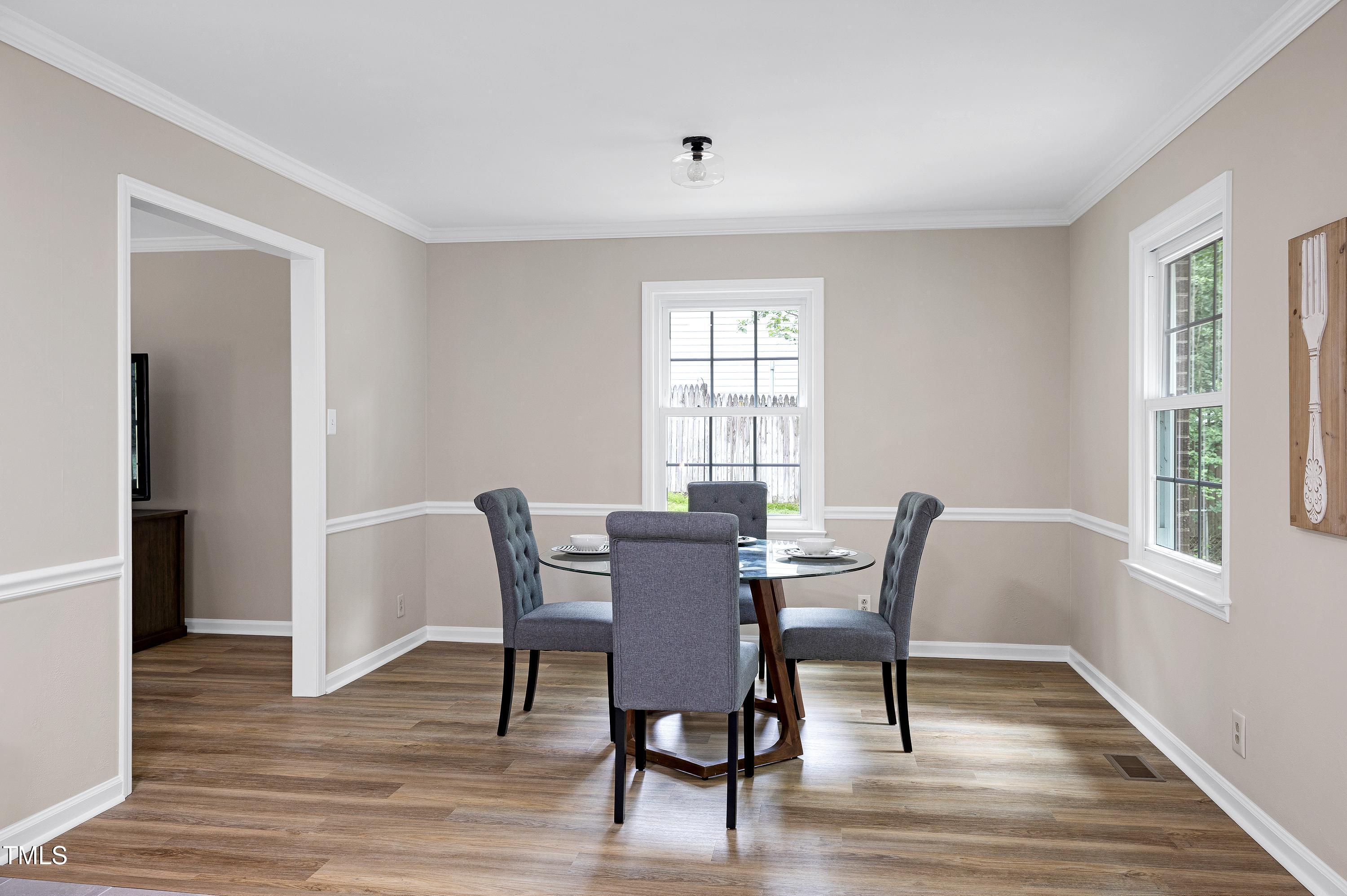 5121 Raintree Road Durham, NC 27712 - Photo 17 of 59 a view of a dining room with furniture window and wooden floor