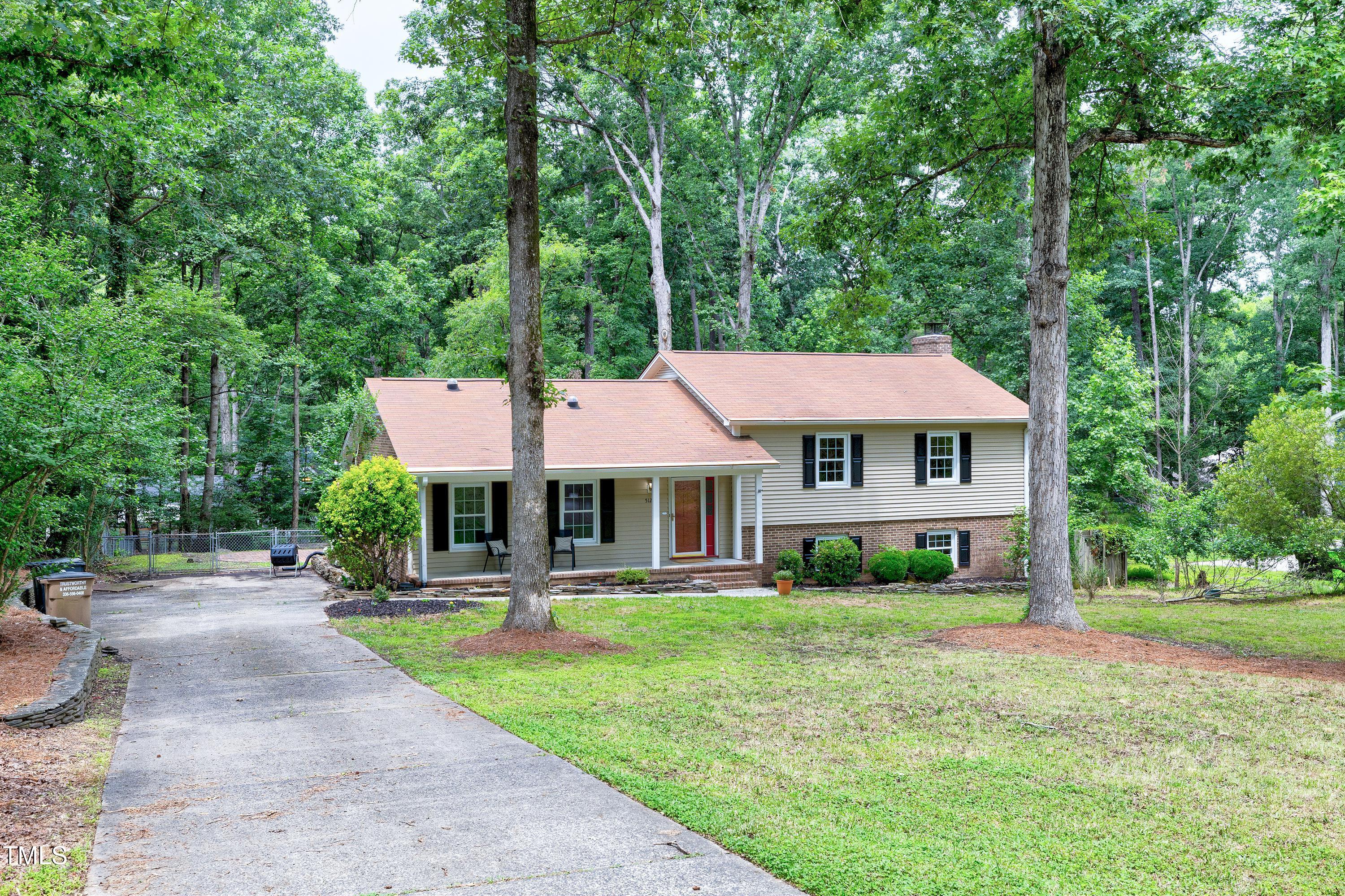 5121 Raintree Road Durham, NC 27712 - Photo 2 of 59 a front view of a house with garden