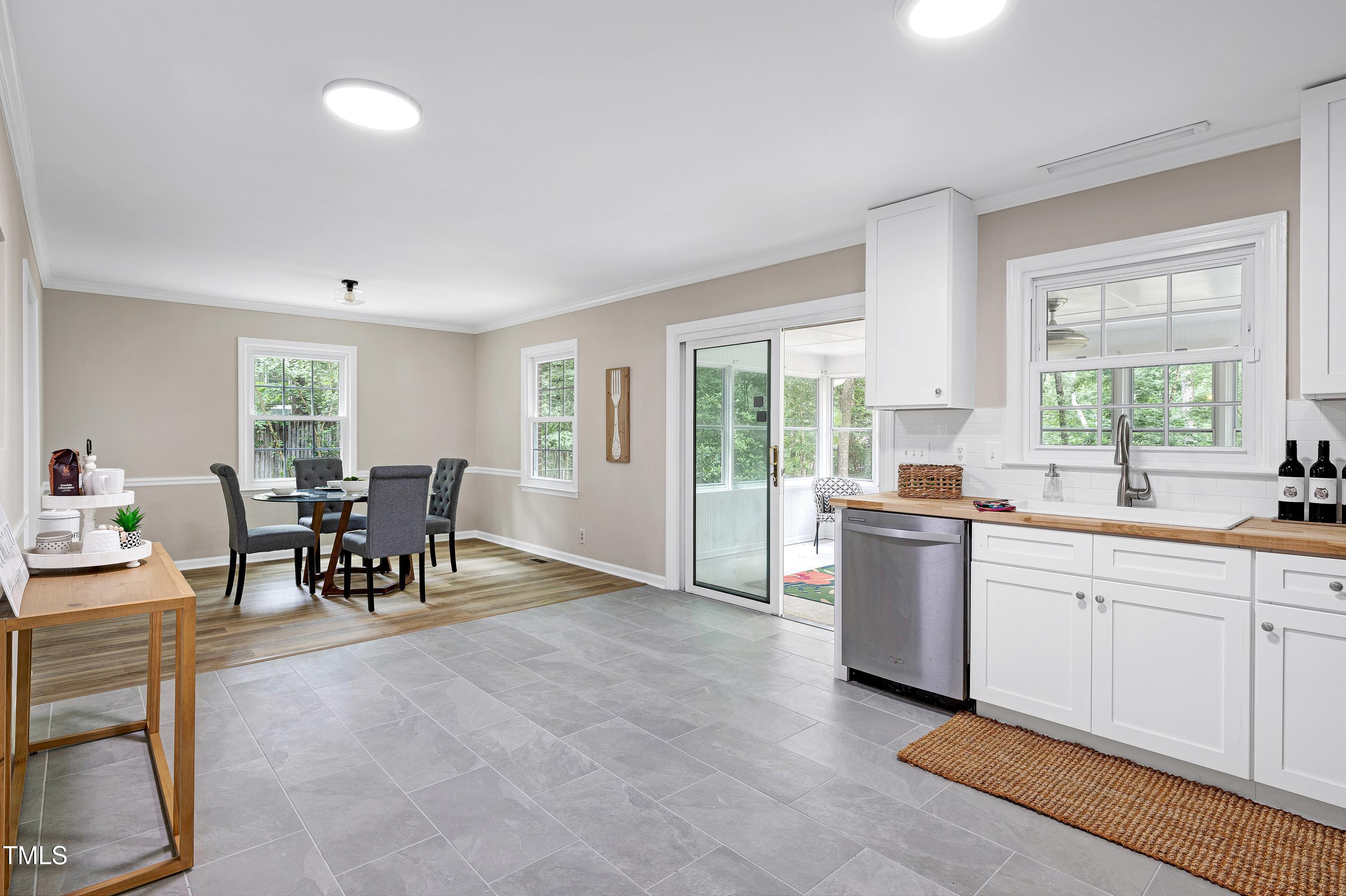 5121 Raintree Road Durham, NC 27712 - Photo 22 of 59 a kitchen with granite countertop cabinets and living room view