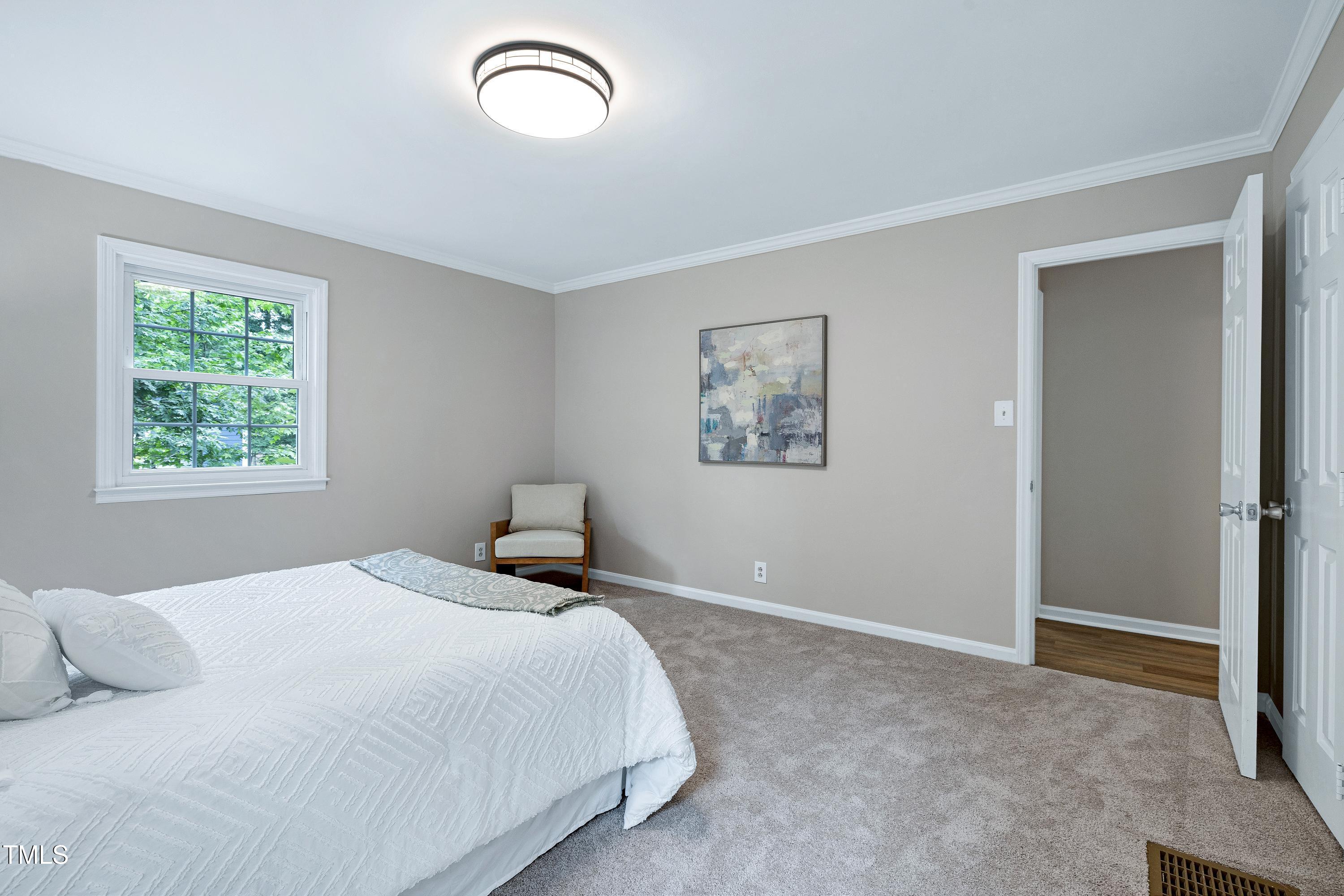 5121 Raintree Road Durham, NC 27712 - Photo 29 of 59 a bedroom with a bed and a window