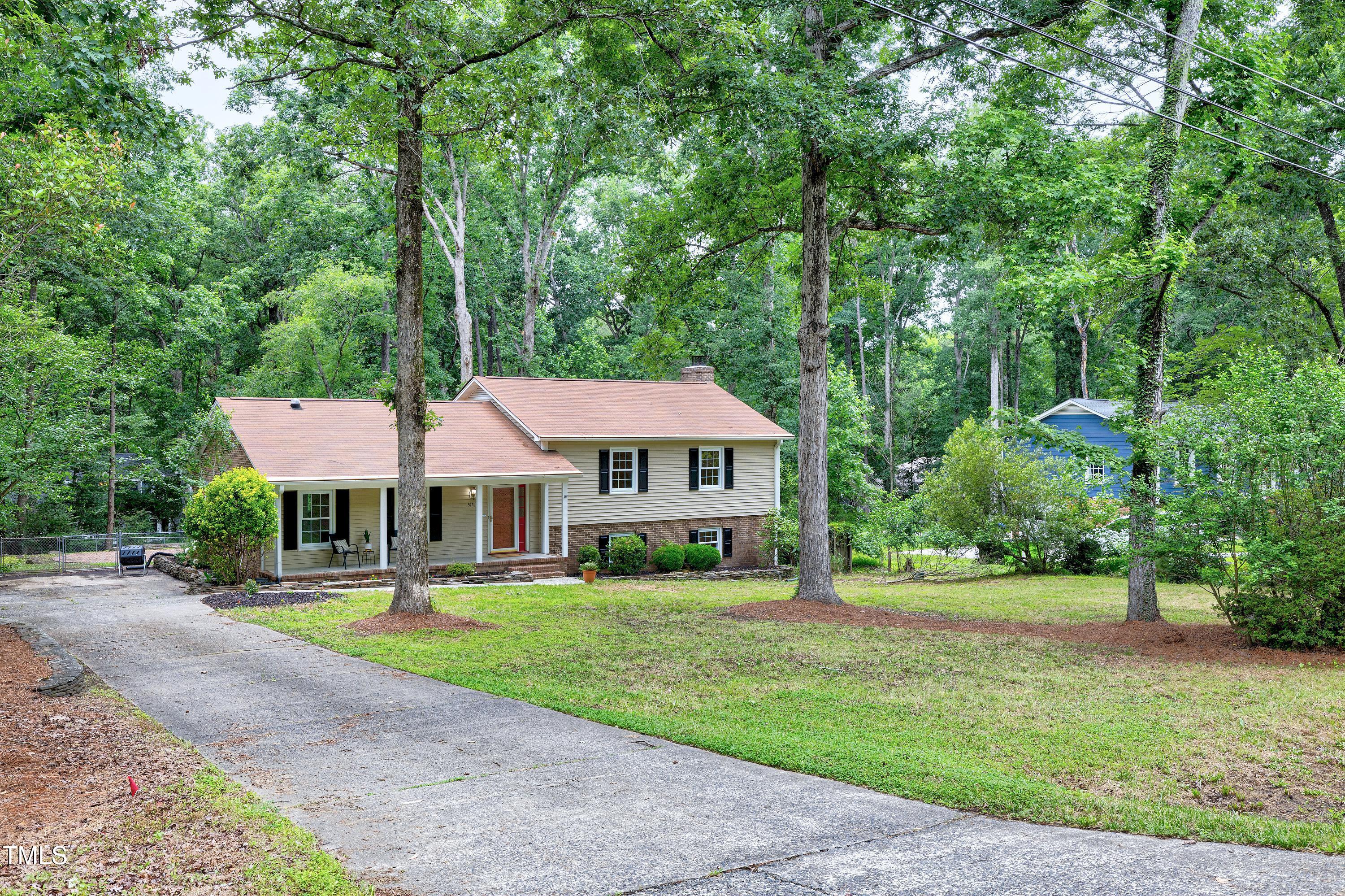 5121 Raintree Road Durham, NC 27712 - Photo 3 of 59 a front view of a house with a garden