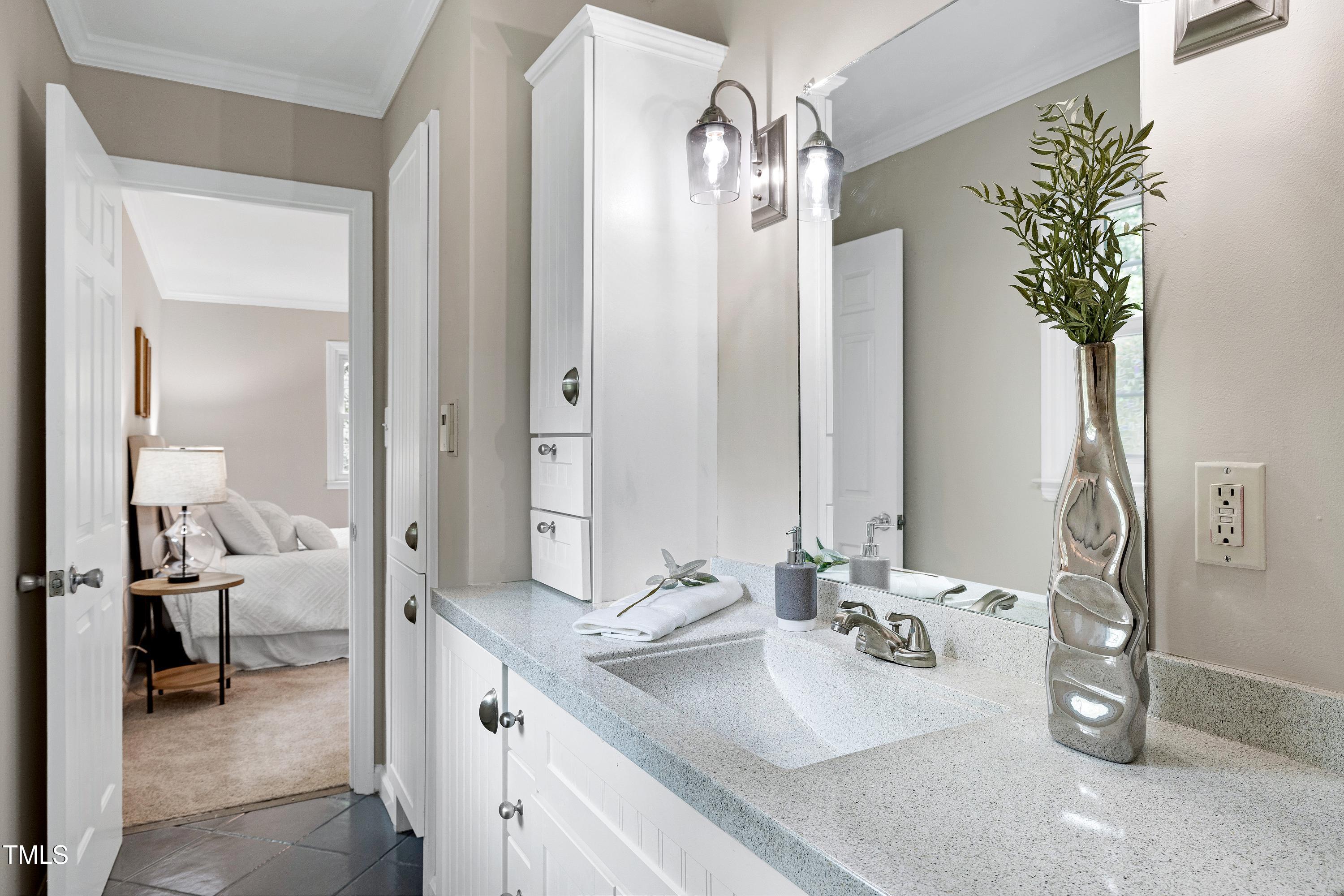 5121 Raintree Road Durham, NC 27712 - Photo 32 of 59 a spacious bathroom with a double vanity sink and a mirror