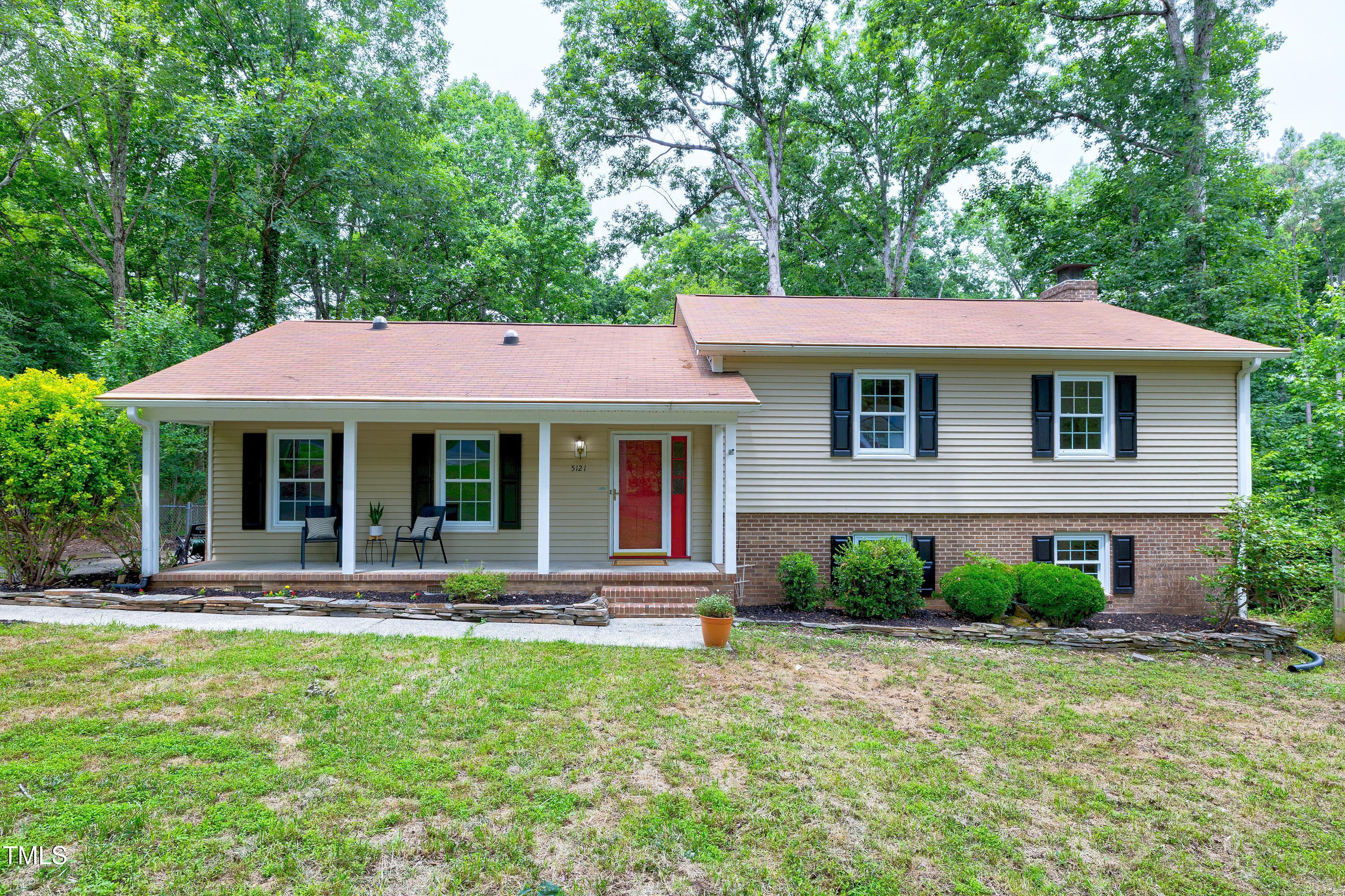 5121 Raintree Road Durham, NC 27712 - Photo 4 of 59 a front view of a house with garden