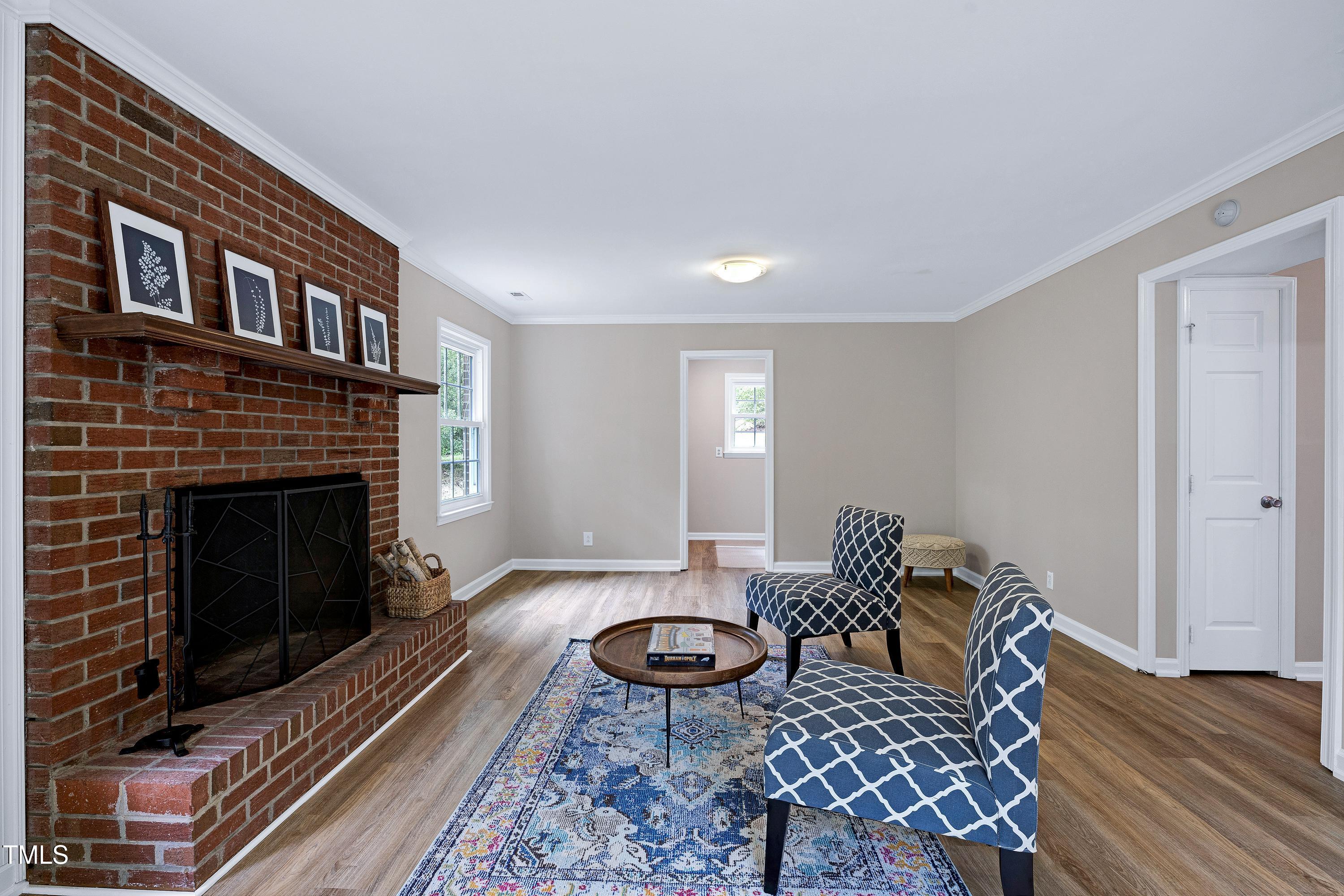 5121 Raintree Road Durham, NC 27712 - Photo 42 of 59 a living room with furniture and a fireplace