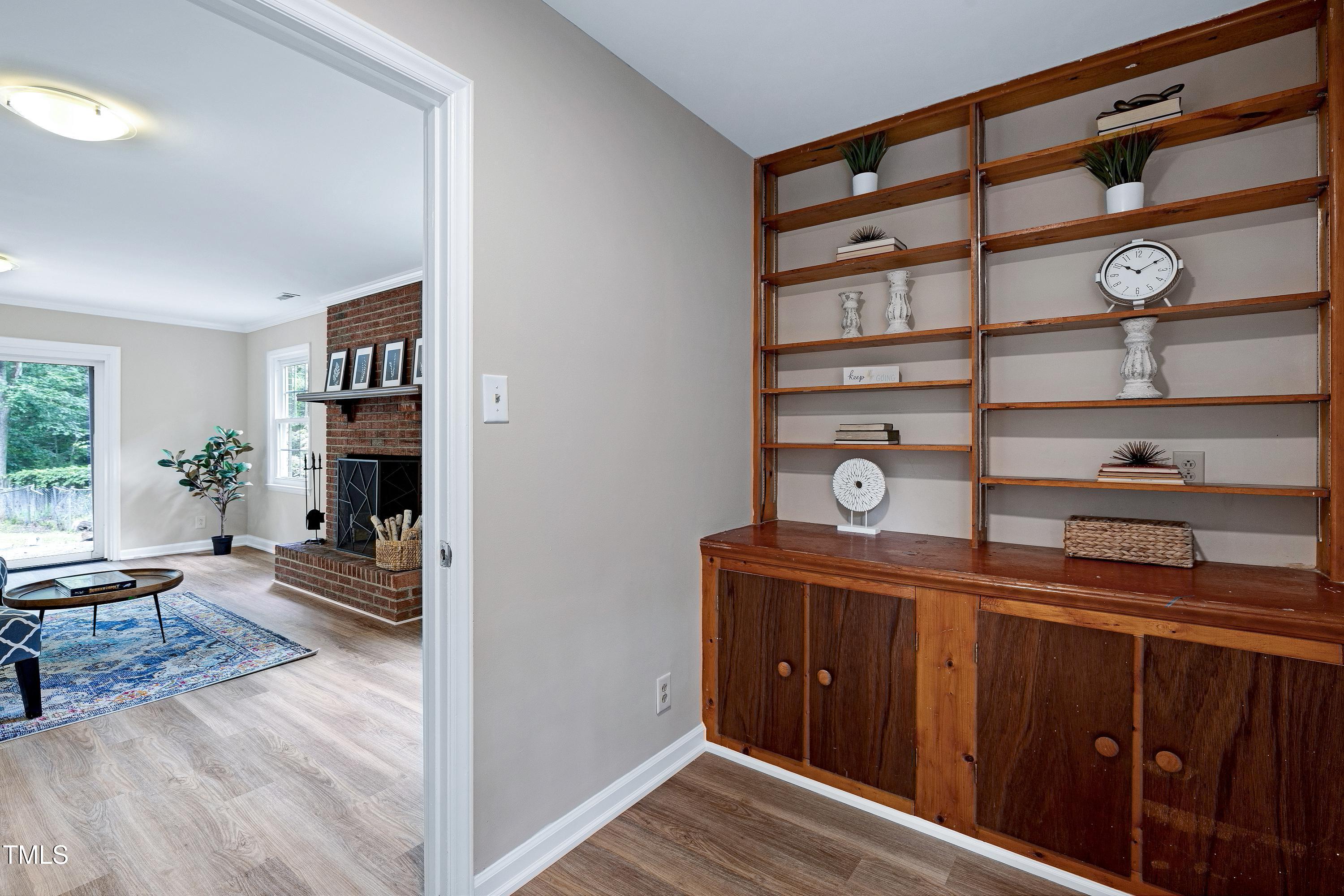 5121 Raintree Road Durham, NC 27712 - Photo 44 of 59 a view of a hallway with wooden floor and a cabinet