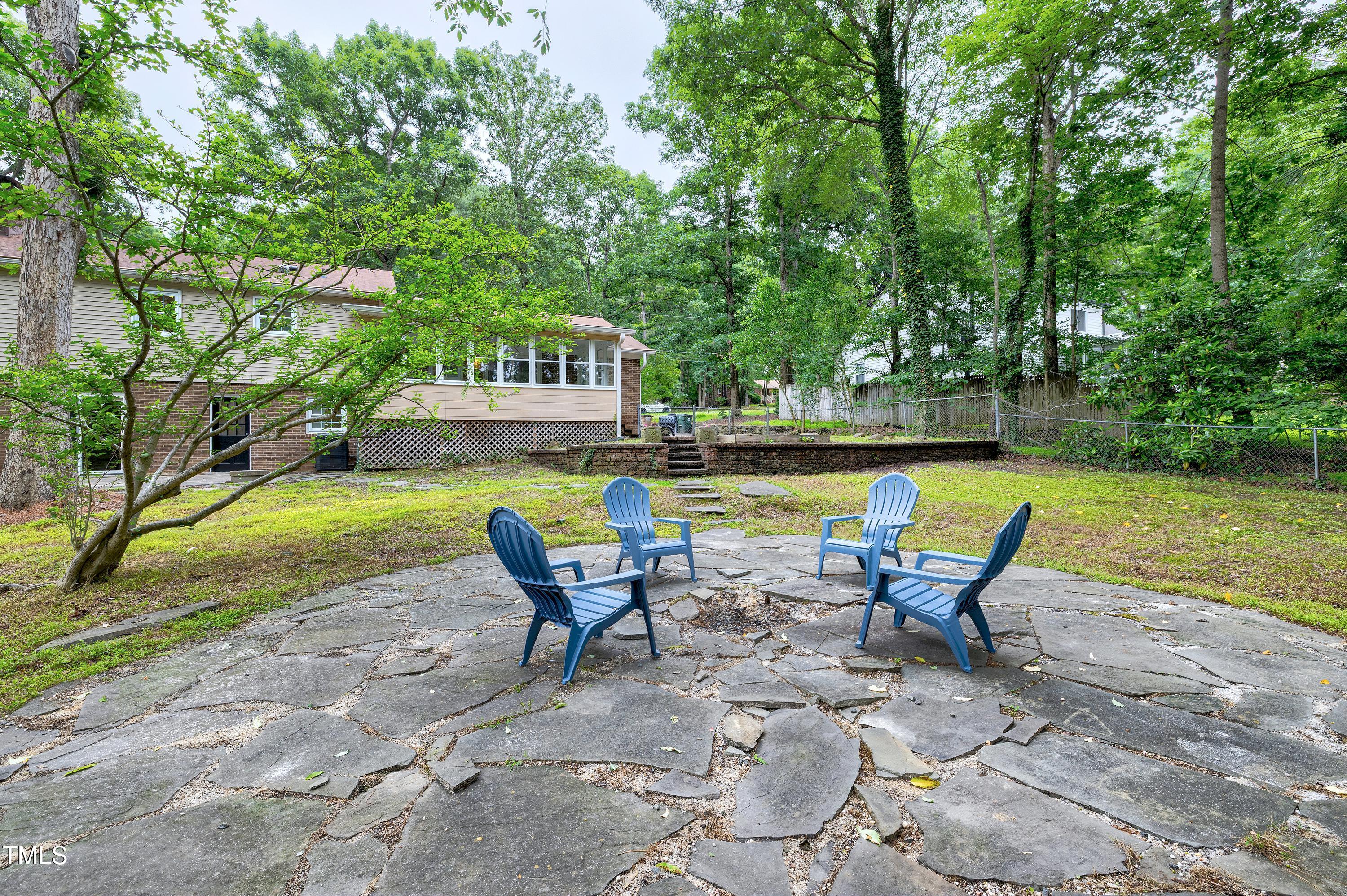 5121 Raintree Road Durham, NC 27712 - Photo 54 of 59 a view of a swimming pool with lounge chairs in back yard of the house