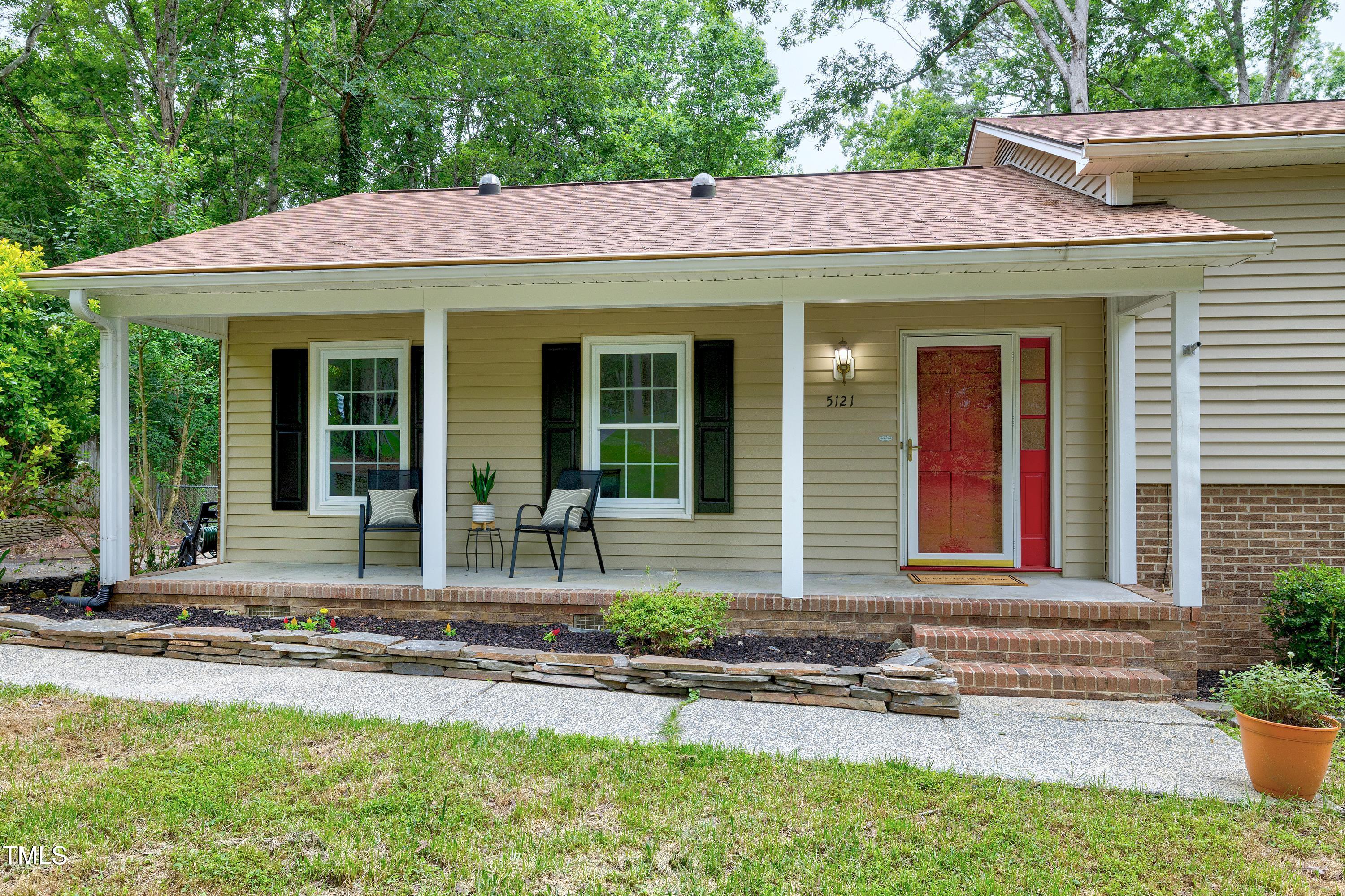 5121 Raintree Road Durham, NC 27712 - Photo 6 of 59 a front view of a house with porch and garden