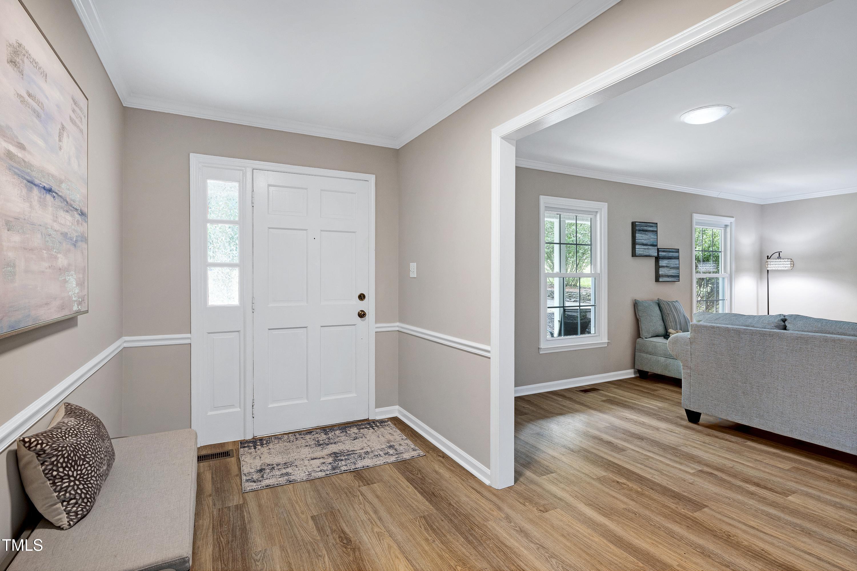 5121 Raintree Road Durham, NC 27712 - Photo 10 of 59 a view of an empty room with wooden floor and a window