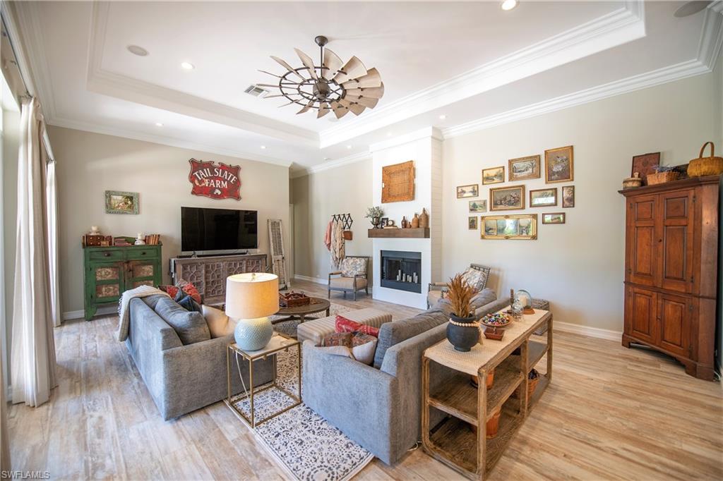 6610 Sable Ridge Lane Naples, FL 34109 - Photo 14 of 50 a living room with fireplace furniture and a flat screen tv
