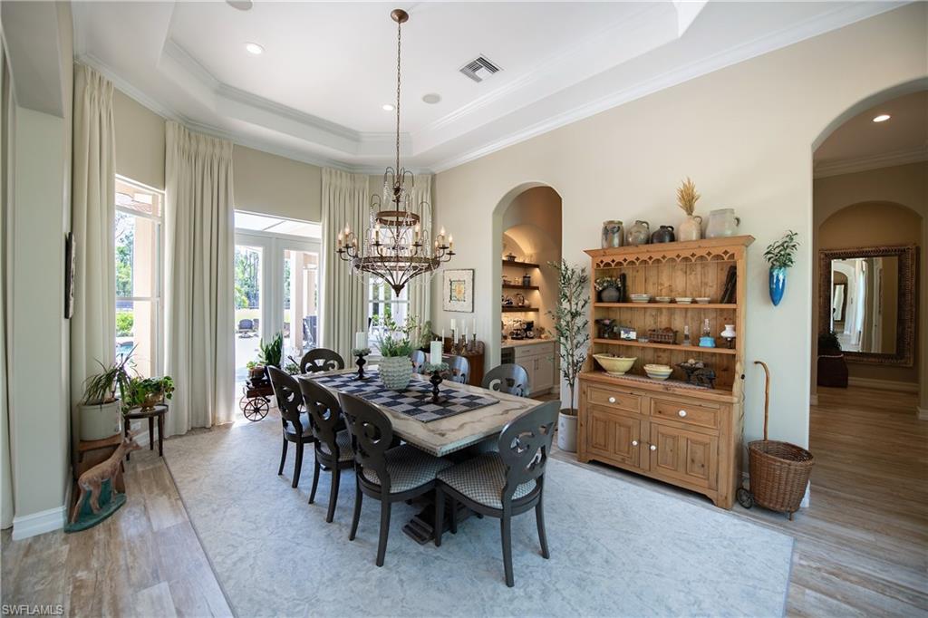 6610 Sable Ridge Lane Naples, FL 34109 - Photo 15 of 50 a view of a dining room with furniture window and wooden floor