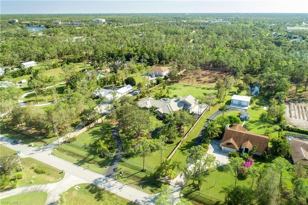6610 Sable Ridge Lane Naples, FL 34109 - Photo 19 of 50 a view of a garden with a lake