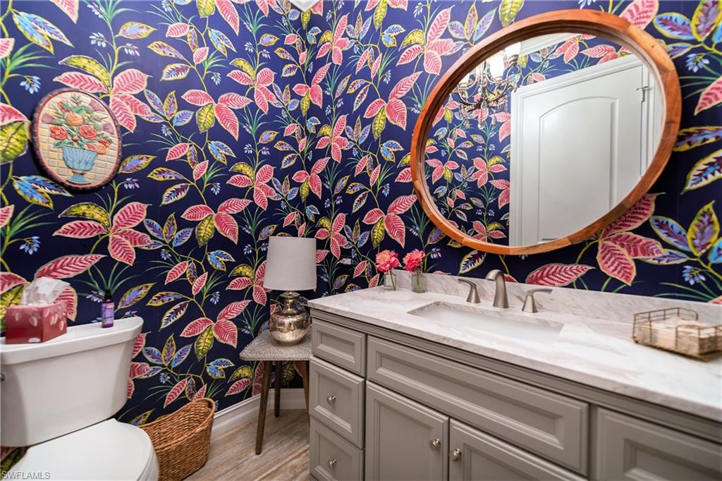 6610 Sable Ridge Lane Naples, FL 34109 - Photo 20 of 50 a bathroom with a sink mirror vanity and toilet