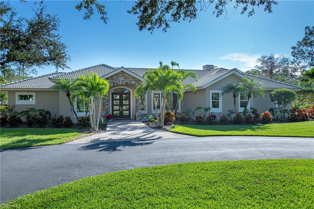 6610 Sable Ridge Lane Naples, FL 34109 - Photo 24 of 50 a view of outdoor space yard and front view of a house