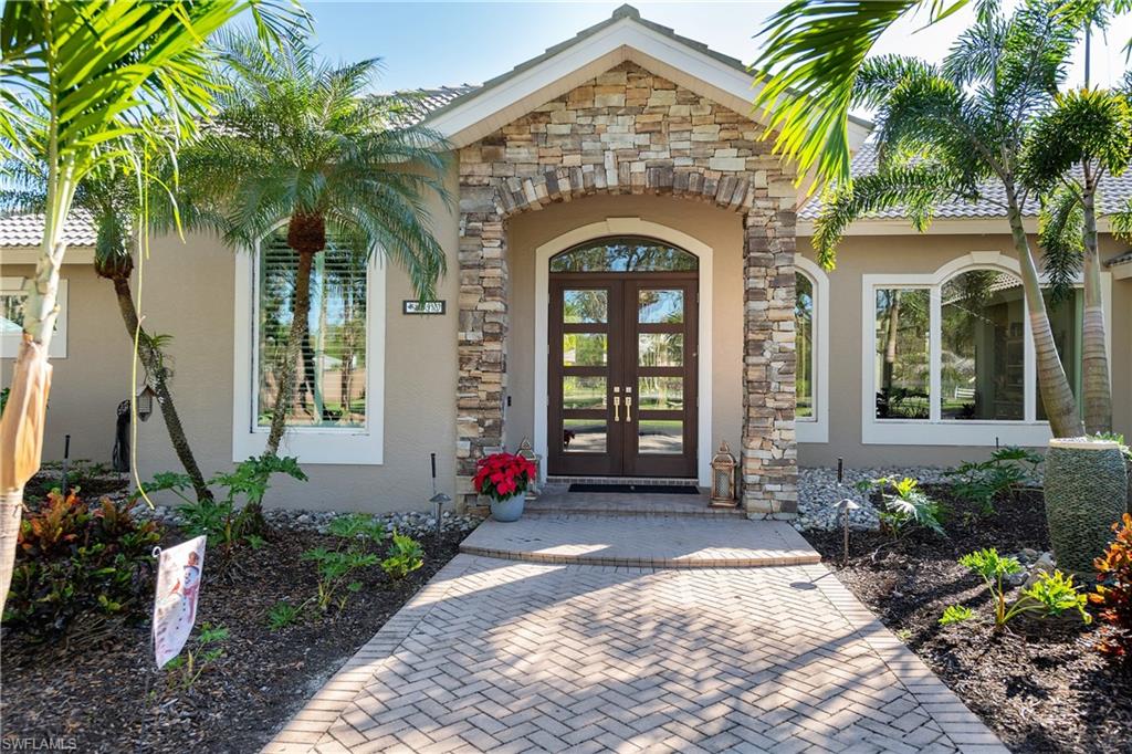 6610 Sable Ridge Lane Naples, FL 34109 - Photo 25 of 50 a front view of a house with a yard
