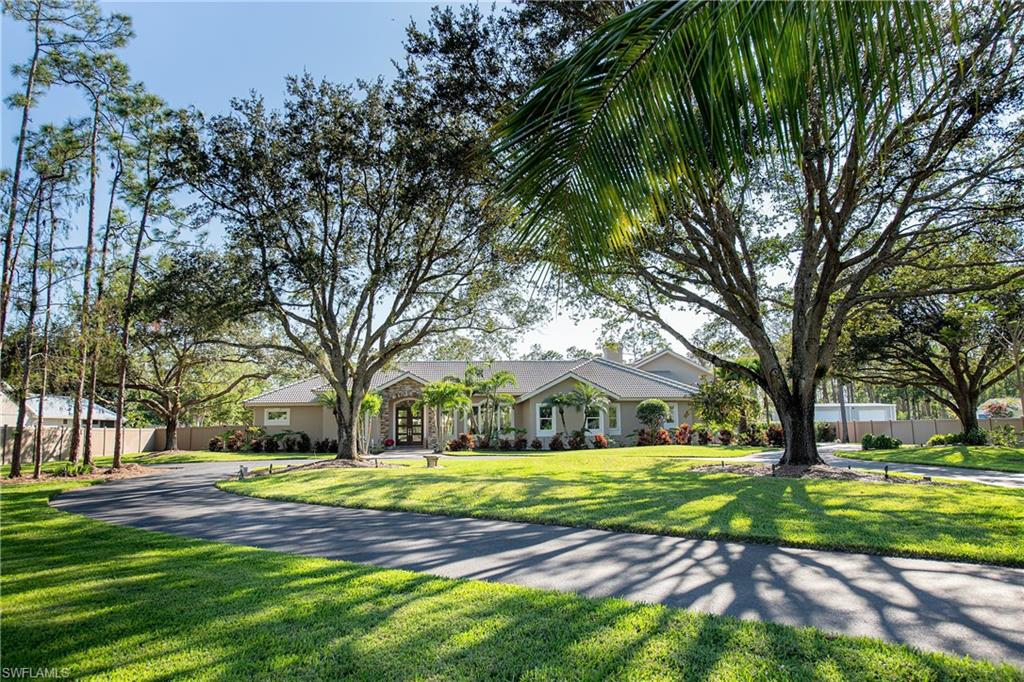 6610 Sable Ridge Lane Naples, FL 34109 - Photo 3 of 50 a view of swimming pool with trees in the background