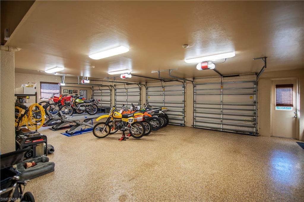 6610 Sable Ridge Lane Naples, FL 34109 - Photo 31 of 50 a view of a garage with a bike and car