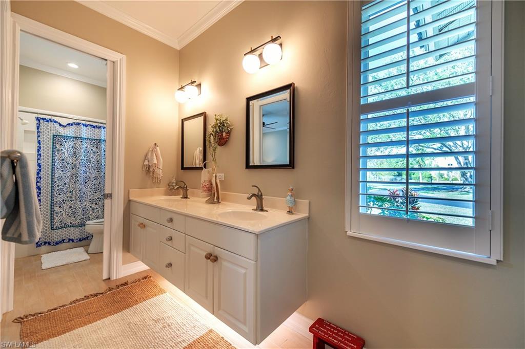 6610 Sable Ridge Lane Naples, FL 34109 - Photo 32 of 50 a bathroom with a double vanity sink a mirror and a shower