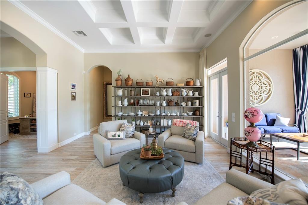 6610 Sable Ridge Lane Naples, FL 34109 - Photo 41 of 50 a living room with furniture and a chandelier