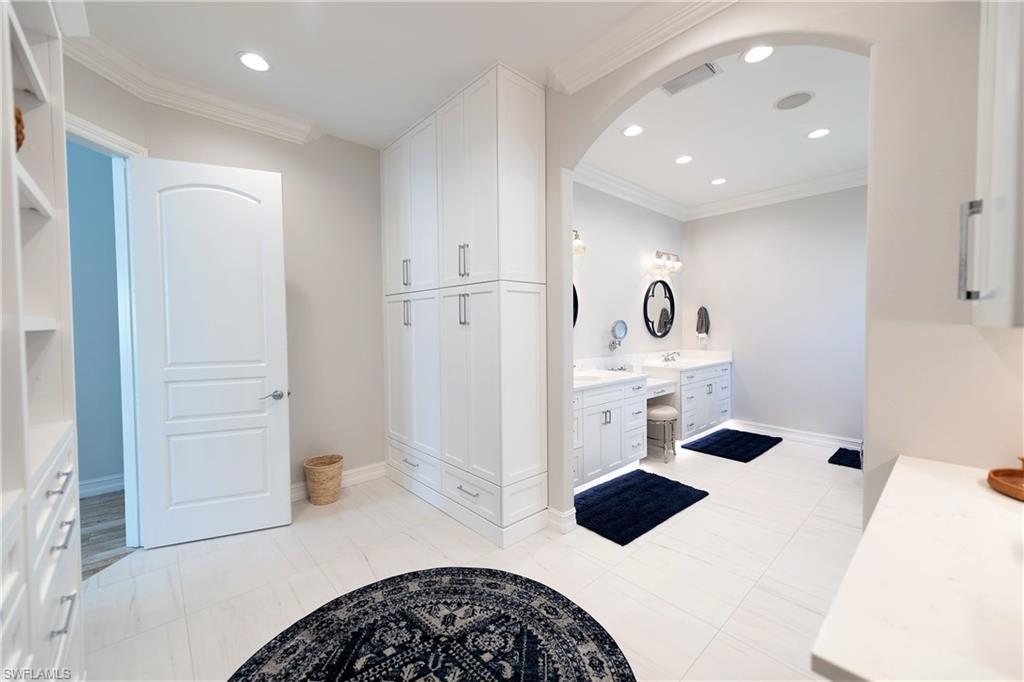 6610 Sable Ridge Lane Naples, FL 34109 - Photo 42 of 50 a bedroom with a bed and cabinets