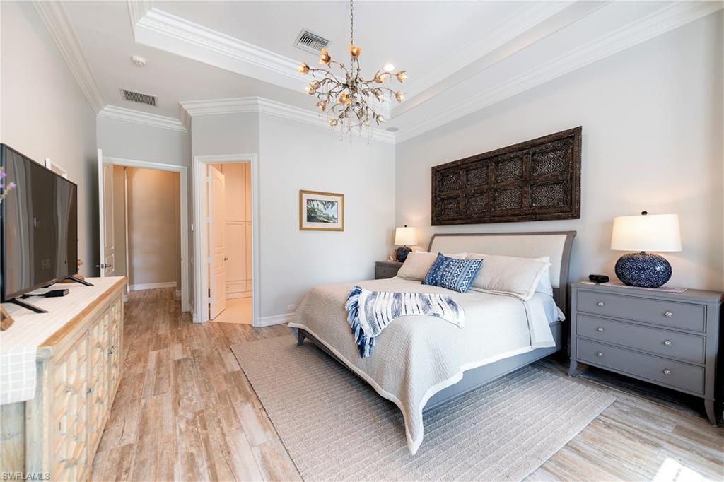 6610 Sable Ridge Lane Naples, FL 34109 - Photo 45 of 50 a bedroom with bed a flat tv screen and dresser