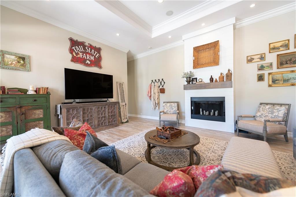 6610 Sable Ridge Lane Naples, FL 34109 - Photo 49 of 50 a living room with furniture and a fireplace