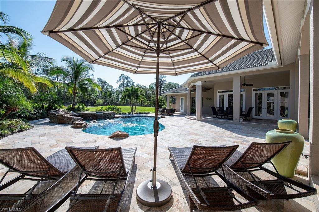 6610 Sable Ridge Lane Naples, FL 34109 - Photo 6 of 50 a view of a patio with table and chairs and potted plants