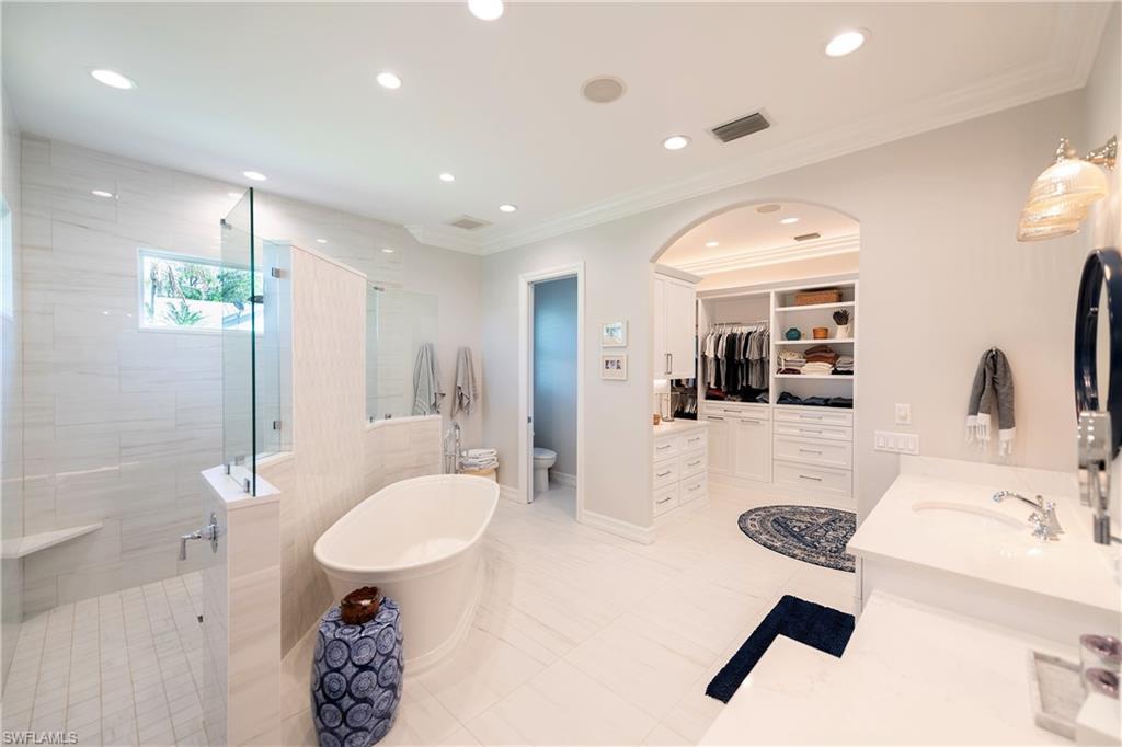 6610 Sable Ridge Lane Naples, FL 34109 - Photo 8 of 50 a bathroom with a sink a toilet and shower