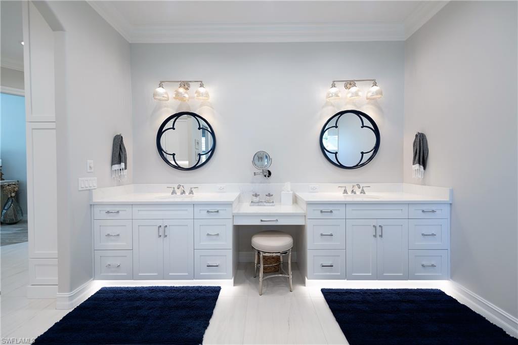 6610 Sable Ridge Lane Naples, FL 34109 - Photo 9 of 50 a spacious bathroom with a double vanity sink and a mirror