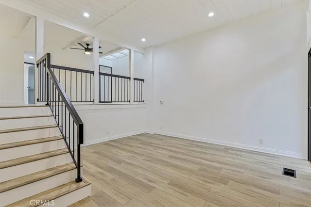 a view of entryway with wooden floor and stairs