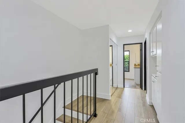 a view of a hallway with wooden floor