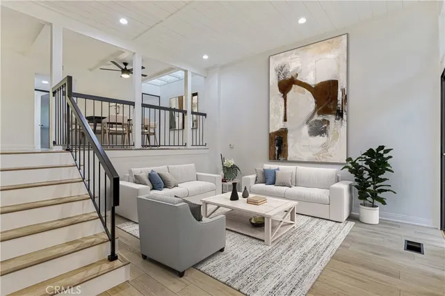 a living room with furniture and a potted plant